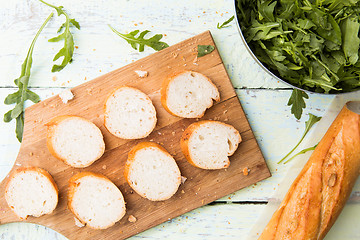 Image showing Photo of cut loaf, greens