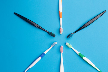 Image showing Multi-colored toothbrushes arranged in circle