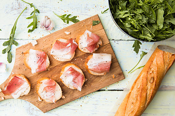 Image showing Baguette with bacon on table