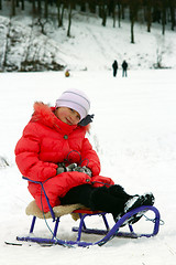 Image showing pretty girl sitting on the sledge