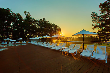 Image showing Relaxing chairs beside swimming pool