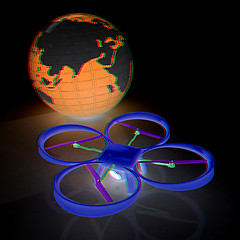 Image showing Quadrocopter Drone with Earth Globe and remote controller on a w