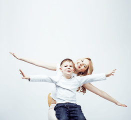 Image showing young modern blond curly mother with cute son together happy smiling family posing cheerful on white background, lifestyle people concept, sister and brother friends 