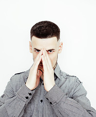 Image showing Portrait of a smart serious young man standing against white background. Emotional concept for gesture 