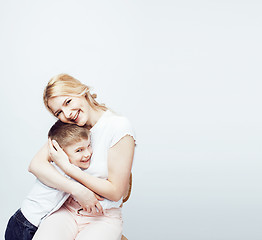 Image showing young modern blond curly mother with cute son together happy smiling family posing cheerful on white background, lifestyle people concept, sister and brother friends 