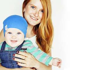 Image showing young beauty mother with cute baby, red head happy modern family smiling isolated on white background close up, lifestyle people concept