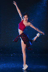 Image showing The young beautiful modern dancer dancing under water drops