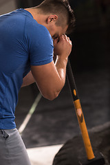 Image showing man workout with hammer and tractor tire