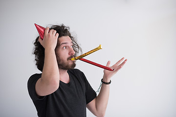 Image showing Portrait of a man in party hat blowing in whistle