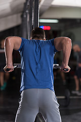 Image showing man doing exercises parallel bars