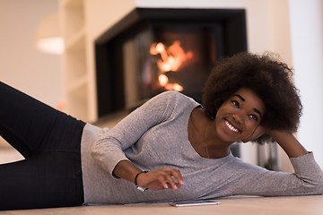 Image showing black women using tablet computer on the floor