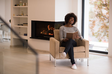 Image showing black woman at home reading book