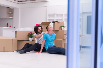 Image showing young  gay couple moving  in new house