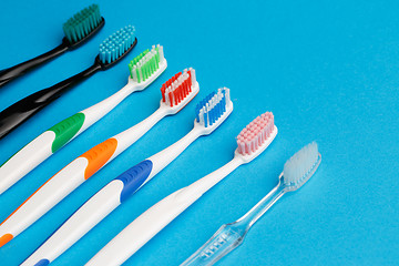 Image showing Photo of seven multi-colored toothbrushes