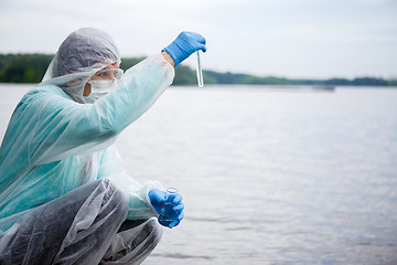 Image showing Biologist takes water for examination