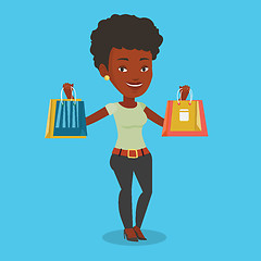 Image showing Happy woman holding shopping bags.