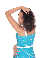 Image showing Hispanic woman in blue dress from the back.