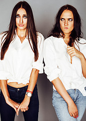 Image showing two sisters twins girl posing, making photo selfie, dressed same white shirt, diverse hairstyle friends, lifestyle people concept