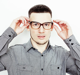 Image showing Portrait of a smart serious young man standing against white background. Emotional concept for gesture 