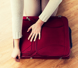 Image showing close up of woman packing travel bag for vacation