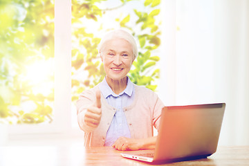 Image showing happy senior woman with laptop showing thumbs up