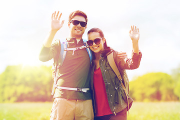 Image showing happy couple with backpacks hiking outdoors