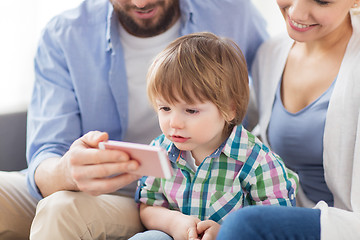 Image showing happy family with smartphone at home