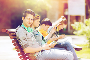 Image showing happy teenage boy with tablet pc and headphones