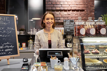 Image showing happy woman or barmaid with cashbox at cafe