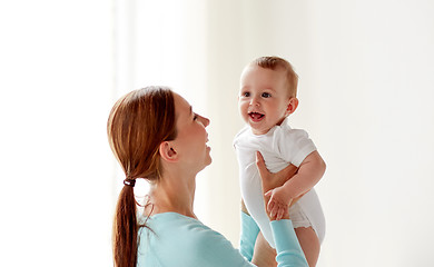 Image showing happy young mother with little baby at home