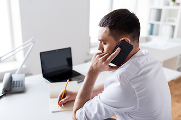 Image showing businessman calling on smartphone at office