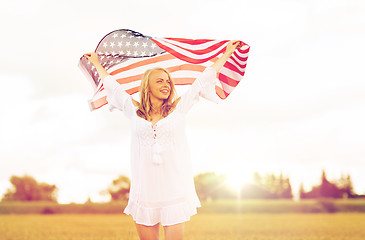 Image showing happy woman with american flag on cereal field