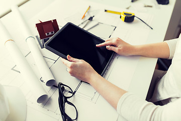 Image showing close up of hand with blueprint and tablet pc