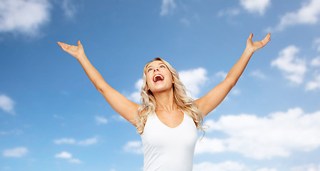 Image showing happy woman celebrating victory over blue sky