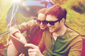 Image showing happy couple with tablet pc at camping tent