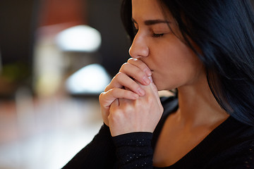 Image showing close up of unhappy woman praying god at funeral