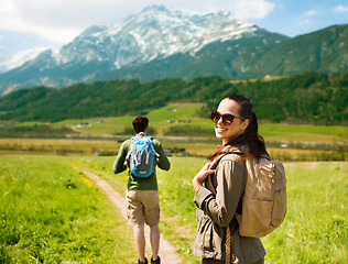 Image showing happy couple with backpacks traveling in highlands