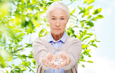 Image showing senior woman with medicine at home