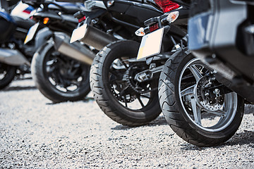 Image showing Motorcycle luxury items close-up: headlights, shock absorber, wheel, wing, toning.