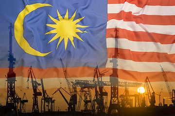 Image showing Industrial concept with Malaysia flag at sunset