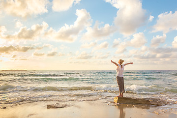 Image showing Free Happy Woman Enjoying Sunset on Sandy Beach