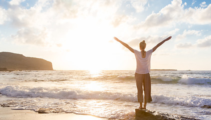 Image showing Free Happy Woman Enjoying Sunset on Sandy Beach