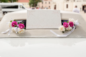 Image showing White wedding limousine decorated with flowers