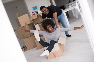 Image showing African American couple  playing with packing material