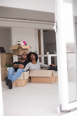 Image showing African American couple  playing with packing material