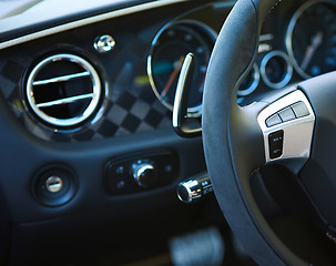 Image showing Control buttons on the steering wheel of a car