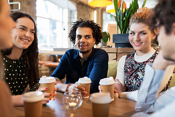 Image showing happy friends drinking coffee at restaurant