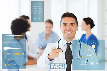 Image showing happy doctor over group of medics at hospital