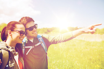 Image showing happy couple with backpacks hiking outdoors