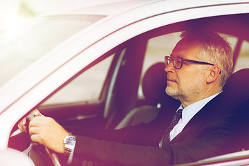 Image showing happy senior businessman driving car